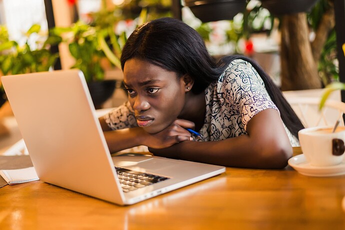 portrait-tired-young-african-woman-sitting-table-with-laptop-computer-while-sleeping-cafe