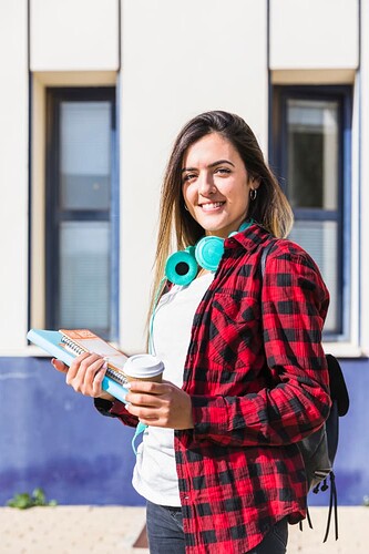 portrait-smiling-university-student-holding-books-disposable-coffee-cup-hand-looking-camera